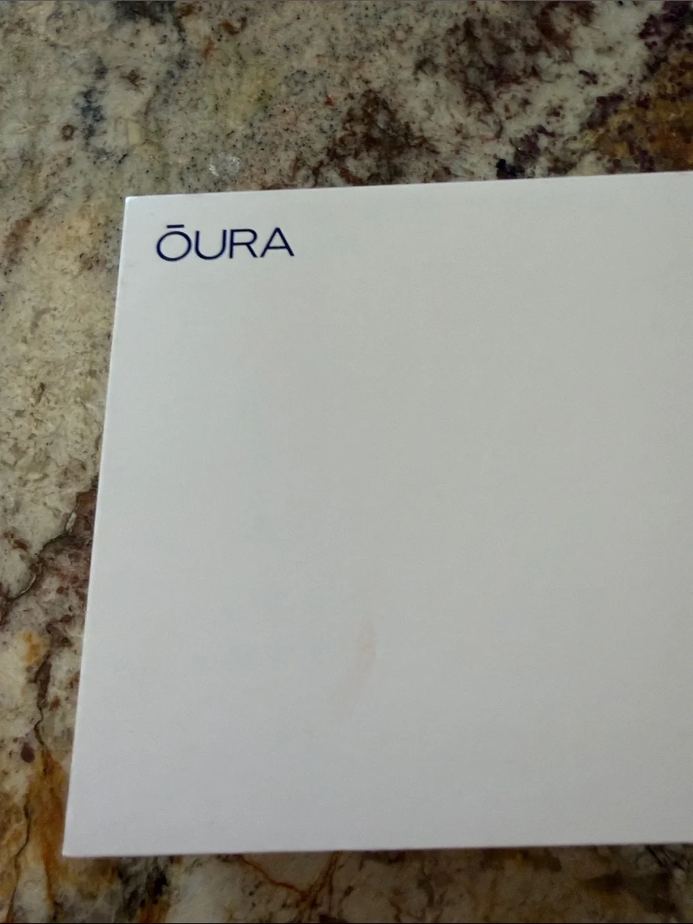 Oura Ring Model Gen 3. Charger for wellness ring with USB cable.